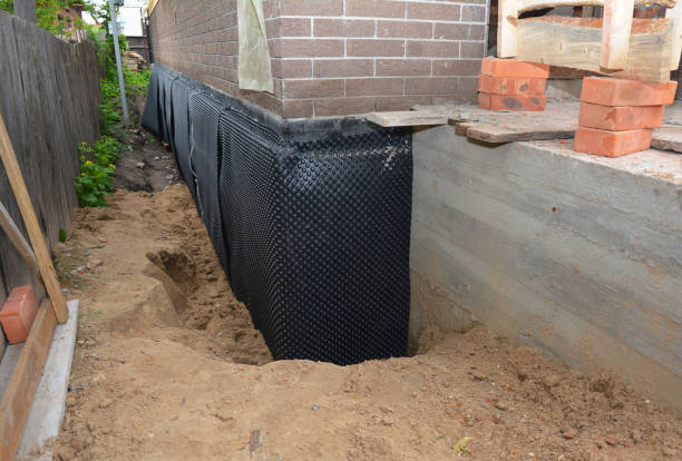 SJ Waterproofing Pros technician performing targeted Interior Drainage System assessment in Johnson City, KS